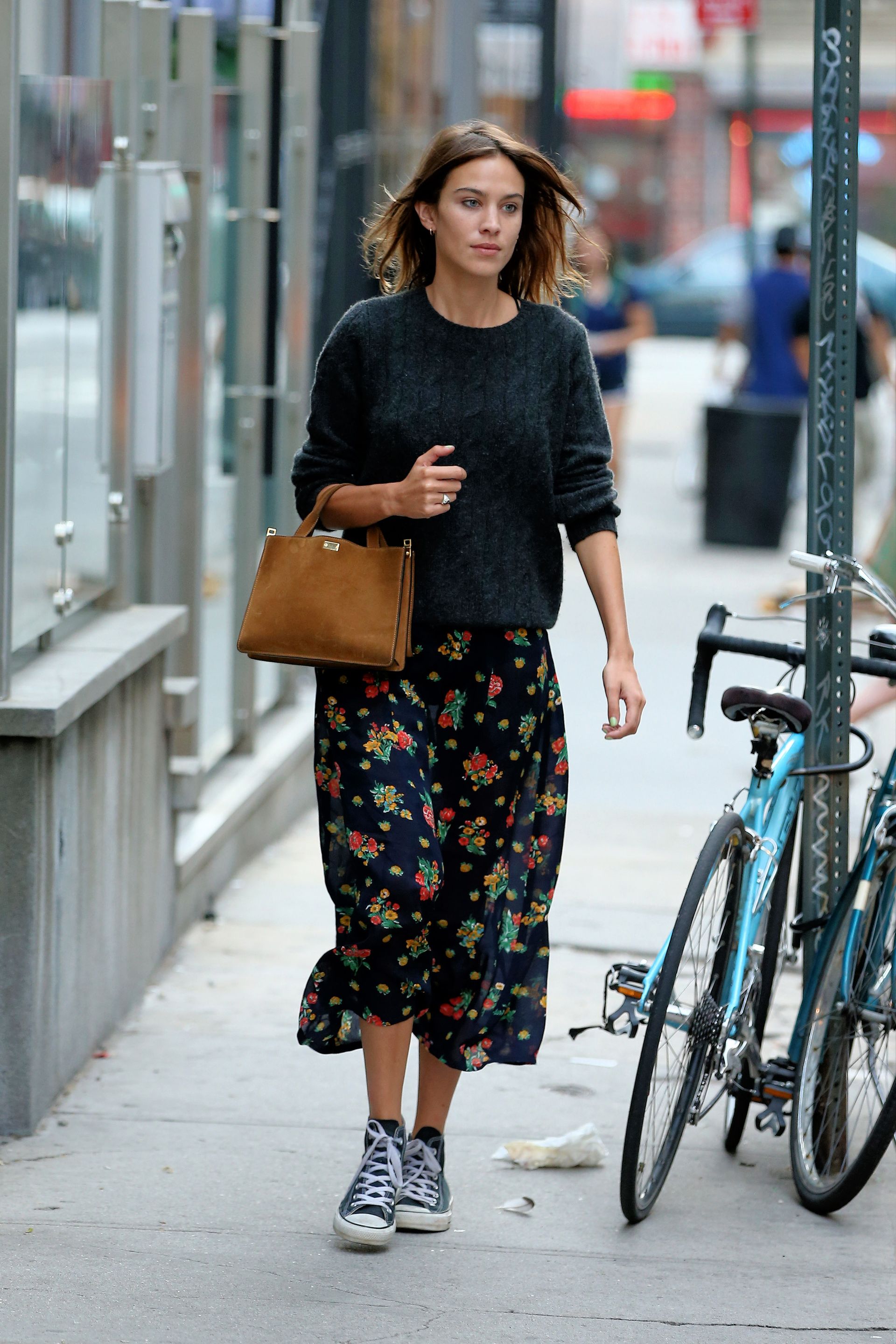 Alexa Chung wears black high top converse.
