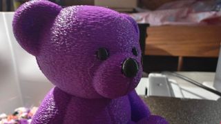 Purple and black "fuzzy" teddy bear