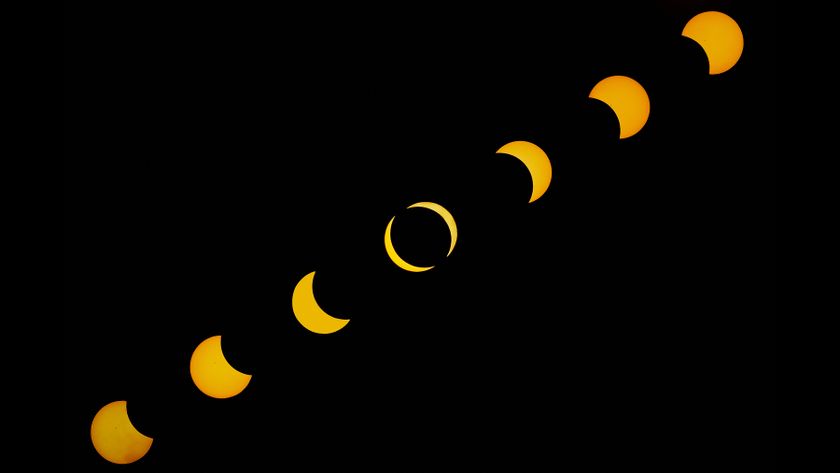 sequence of images showing a partial solar eclipse unfold as the moon takes a larger and larger &quot;bite&quot; out of the sun.