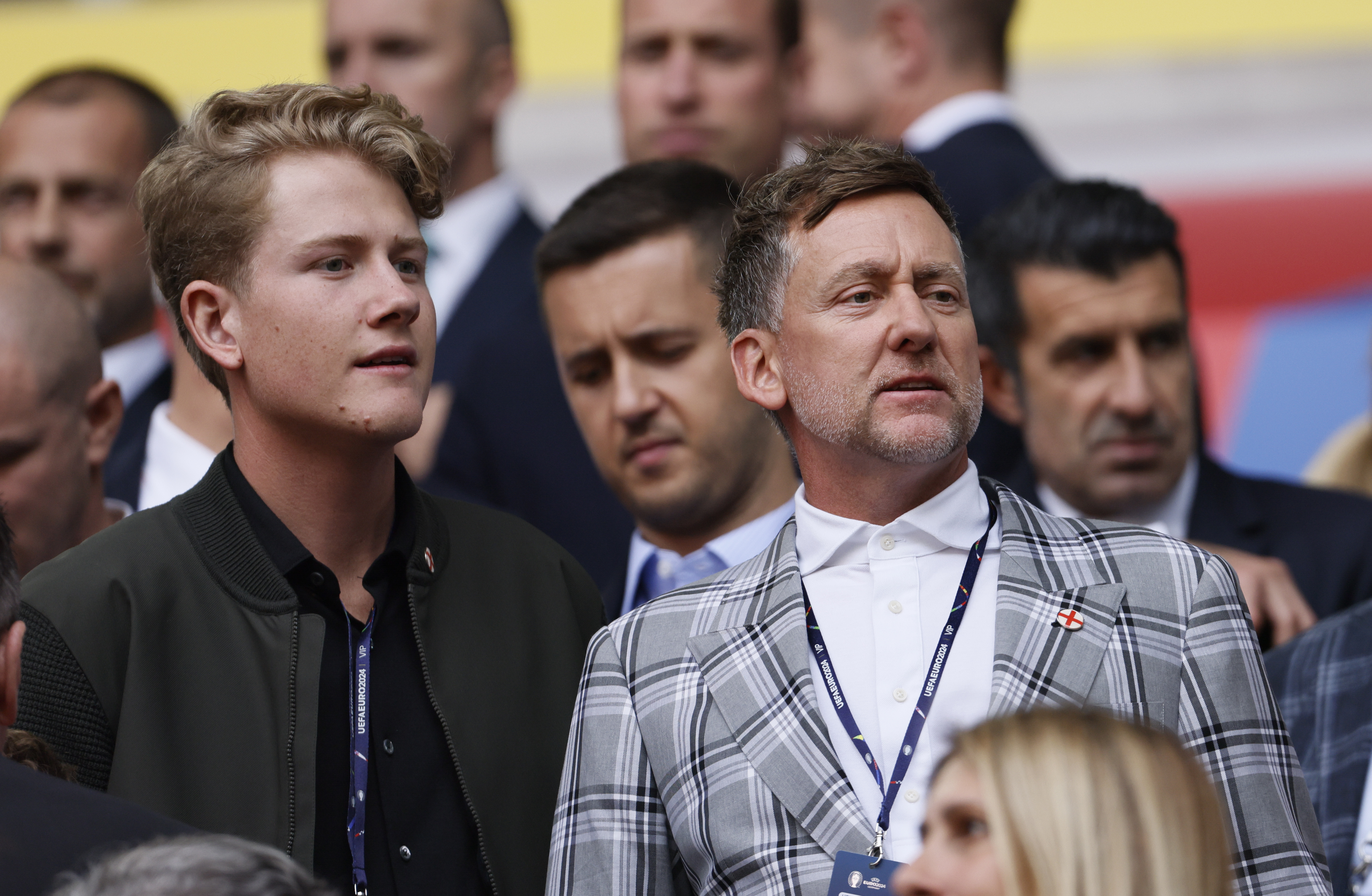 Luke and Ian Poulter watch a football match in the stands
