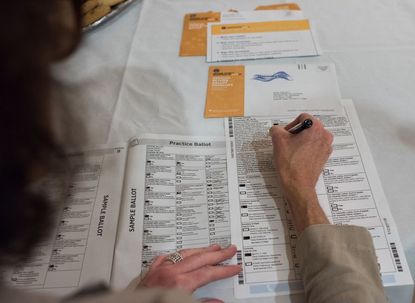 Filling out a mail-in ballot.