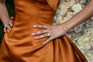 a close up of Zendaya wearing what appears to be an engagement ring at the 2025 Golden Globe awards