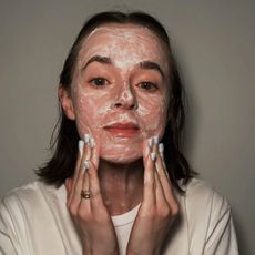 Grace washing her face with a cleanser