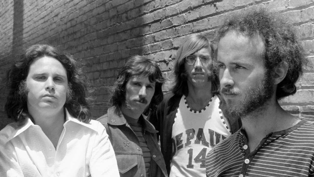 The Doors standing against a brick wall circa 1968