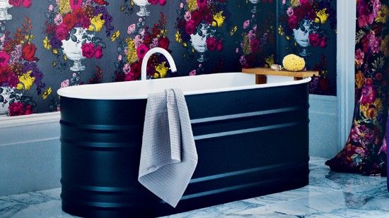 black florals wallpaper in bathroom and freestanding bath