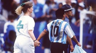 Diego Maradona holds hands with a nurse as he is led away for a drugs test following Argentina's game against Nigeria at the 1994 World Cup.
