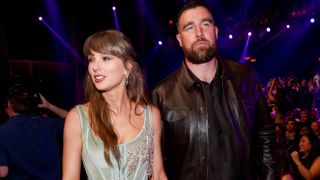 Taylor Swift and Travis Kelce walking hand-in-hand at the iHeart Radio Music Awards on march 26, 2026.