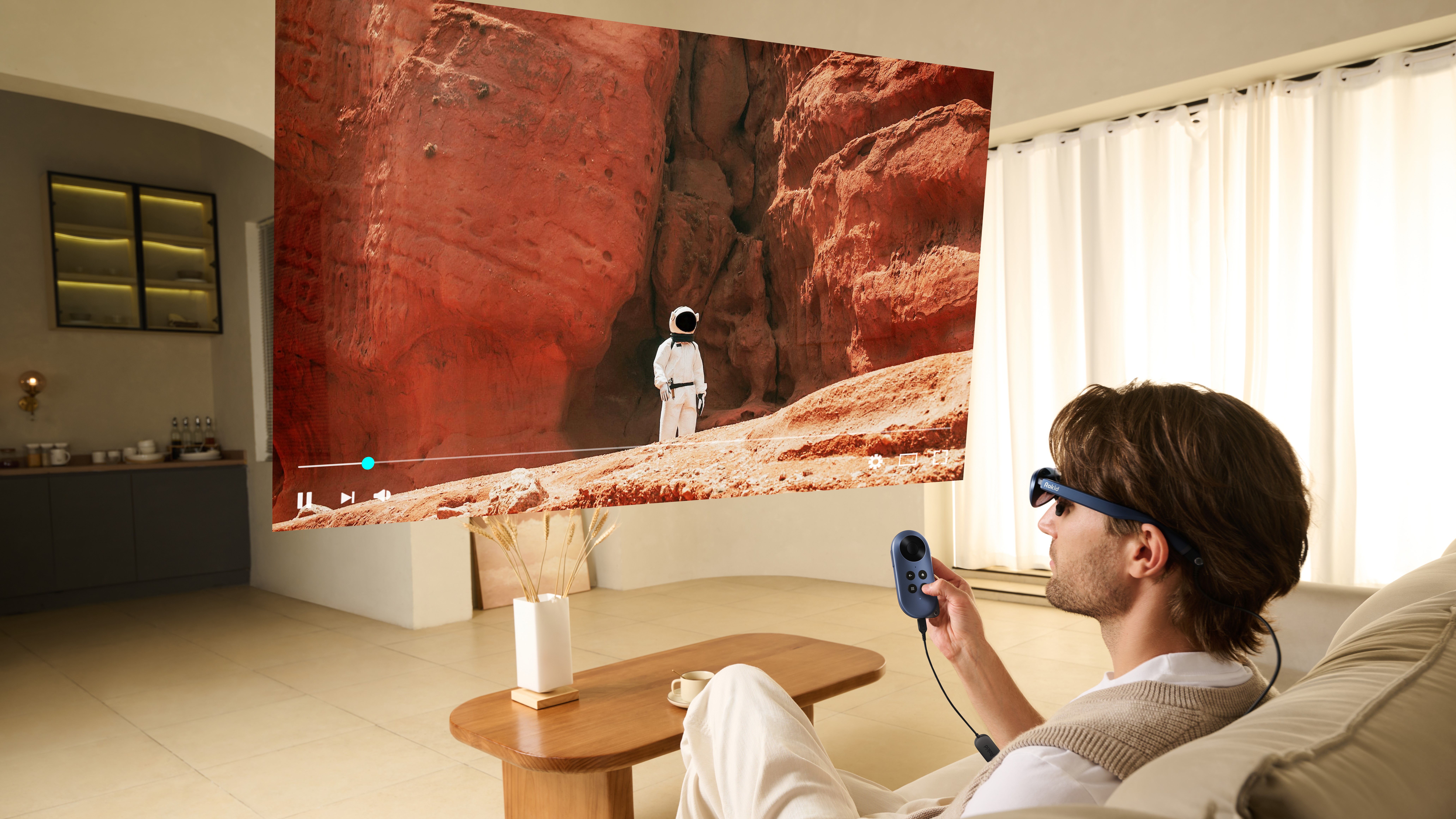A person watching a show with someone in a space suit exploring a red planet, the screen is floating virtually in front of the person thanks to the Rokid AR glasses