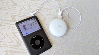 Showing LG Tone Free T90 charging case connected to iPod for Bluetooth transmit to earbuds