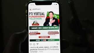 A man checks a social app to monitor the official site of the Pakistan Tehreek-e-Insaf party (PTI) party, as a massive national and global telethon to launch the PTI manifesto and raise campaign funds is launnched, in Islamabad on January 7, 2024.