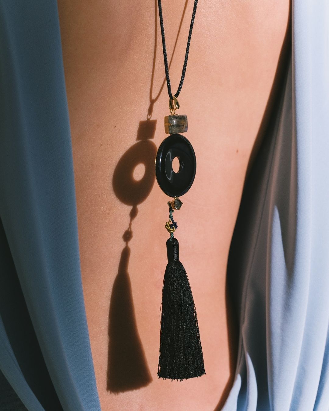 An image of @jenniferbehr&#039;s pendant necklace, and example of one of the biggest party trends for 2025.