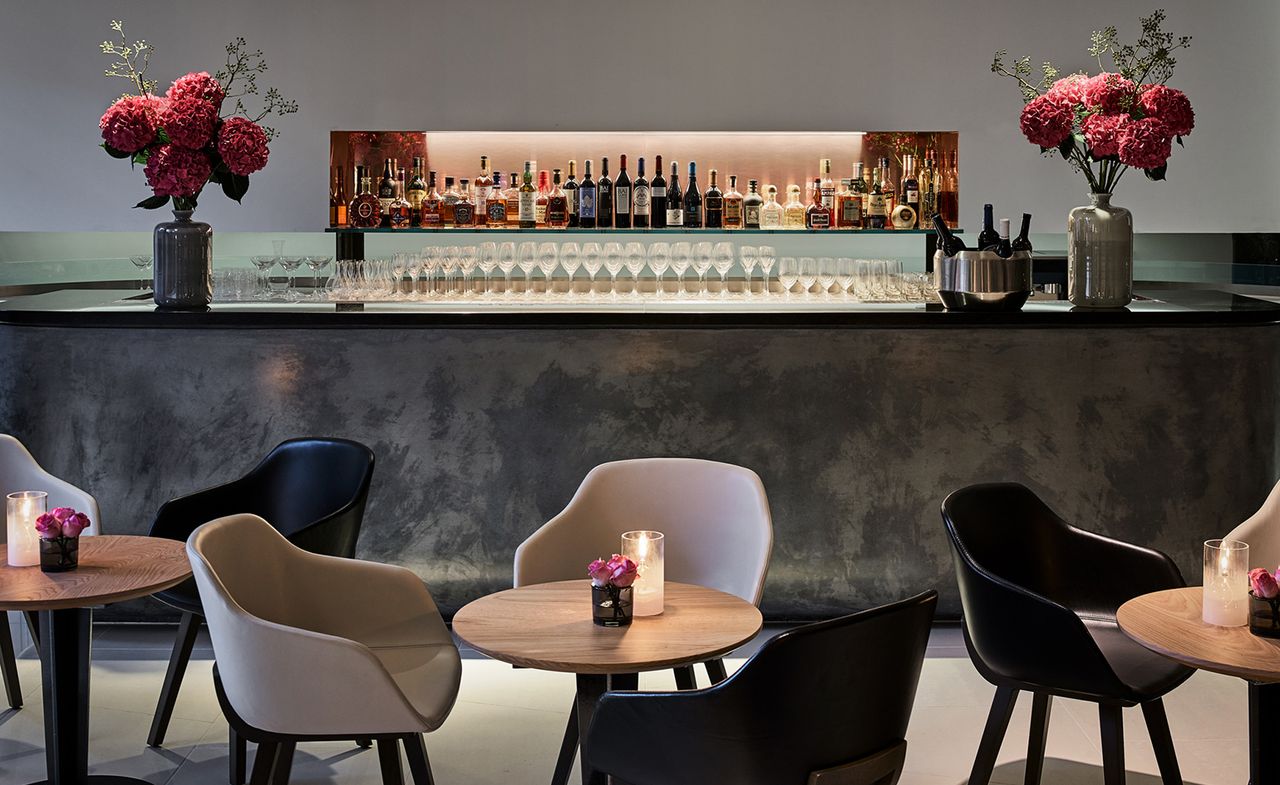 One Aldwych hotel dinning space with wooden table and chair