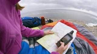 Woman using a gps device for hiking