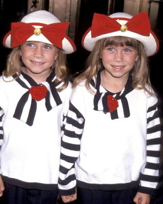 Mary-Kate and Ashley Olsen wearing matching nautical themed outfits as young girls in 1993.