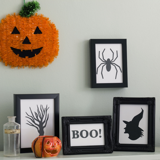 black and white halloween prints frame on white wall