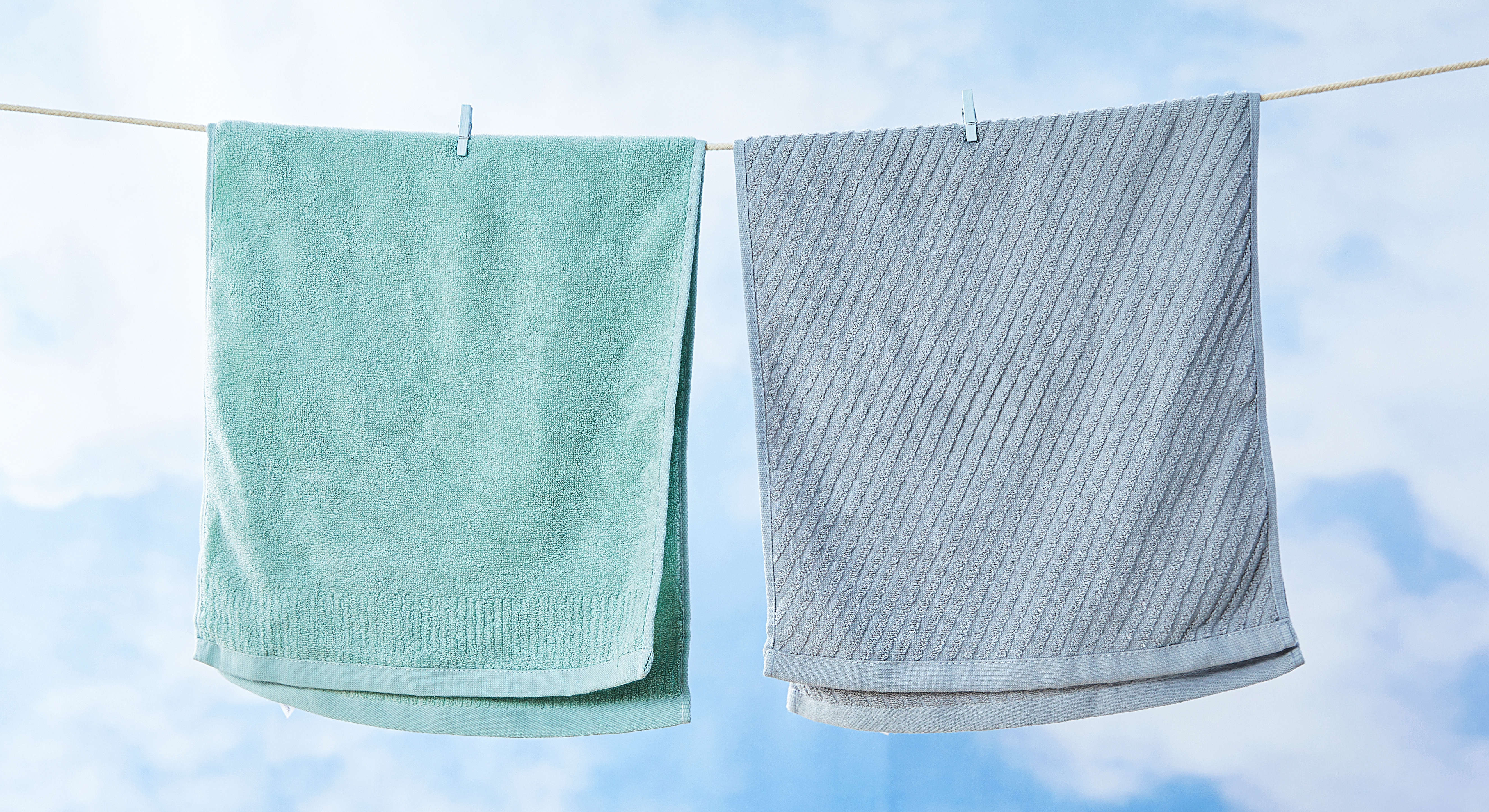 Two towels drying outside on a clothesline