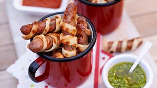 Sausages wrapped in pastry in a red mug