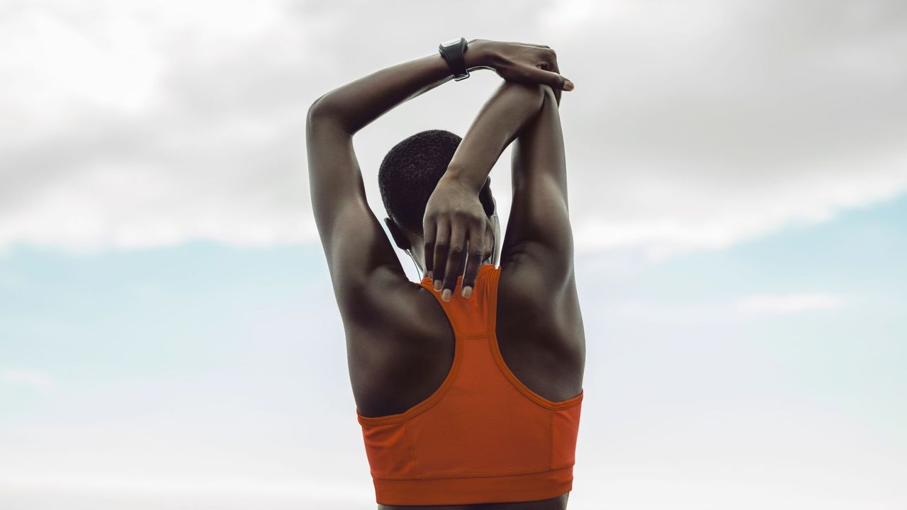 Back workout: A woman stretching her arms after a workout