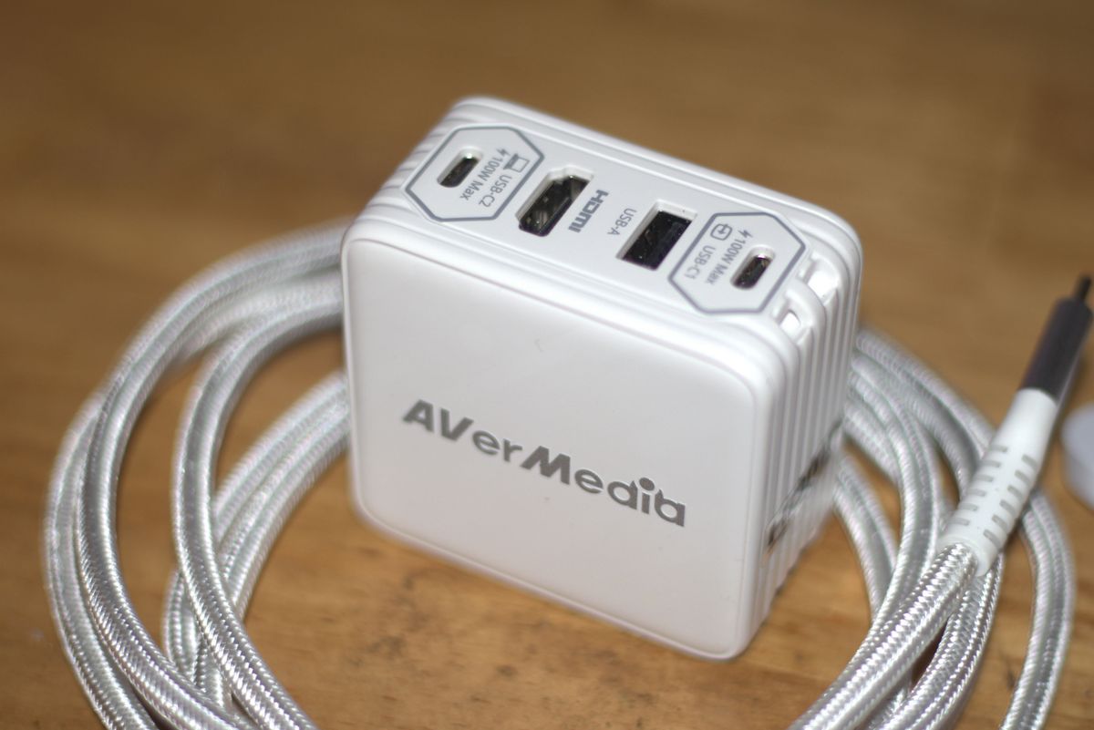 The AVerMedia Elite Go GC313 Pro charging brick and capture card combo in white.