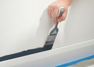 A Harris paint brush cutting in on a skirting board