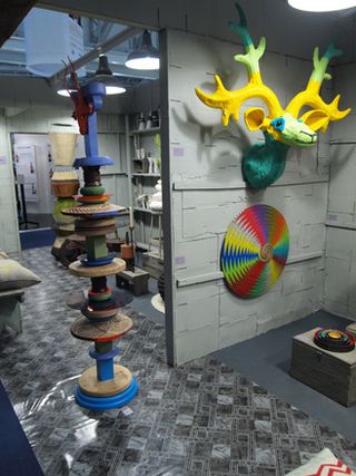 Multiple art sculptures on the wall and floor