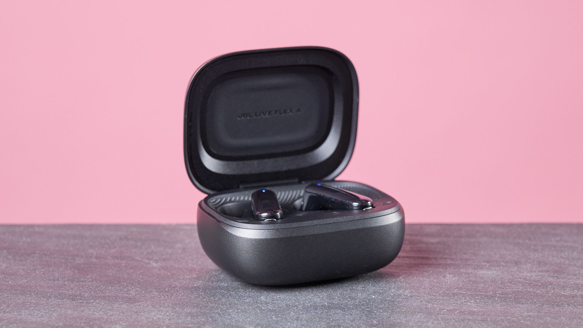 JBL Live Flex 4 on table with charging case open