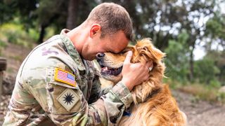 Veteran hugging his dog