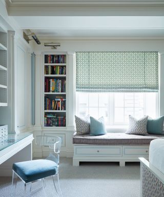 bedroom with blue walls and built-in furniture and window seat
