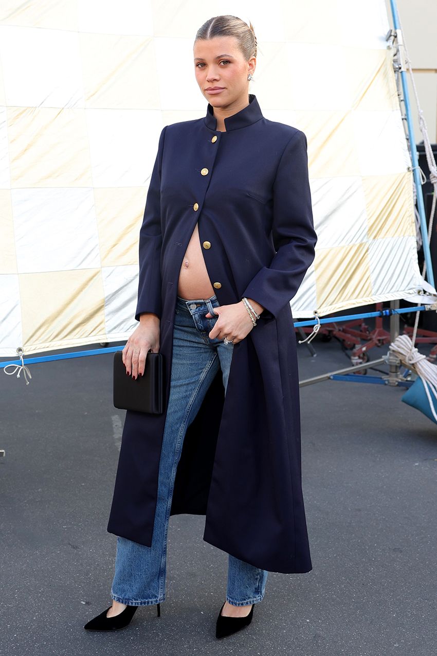 Sofia Richie wearing a navy coat, jeans, and black pumps at Vogue World 100 in Hollywood