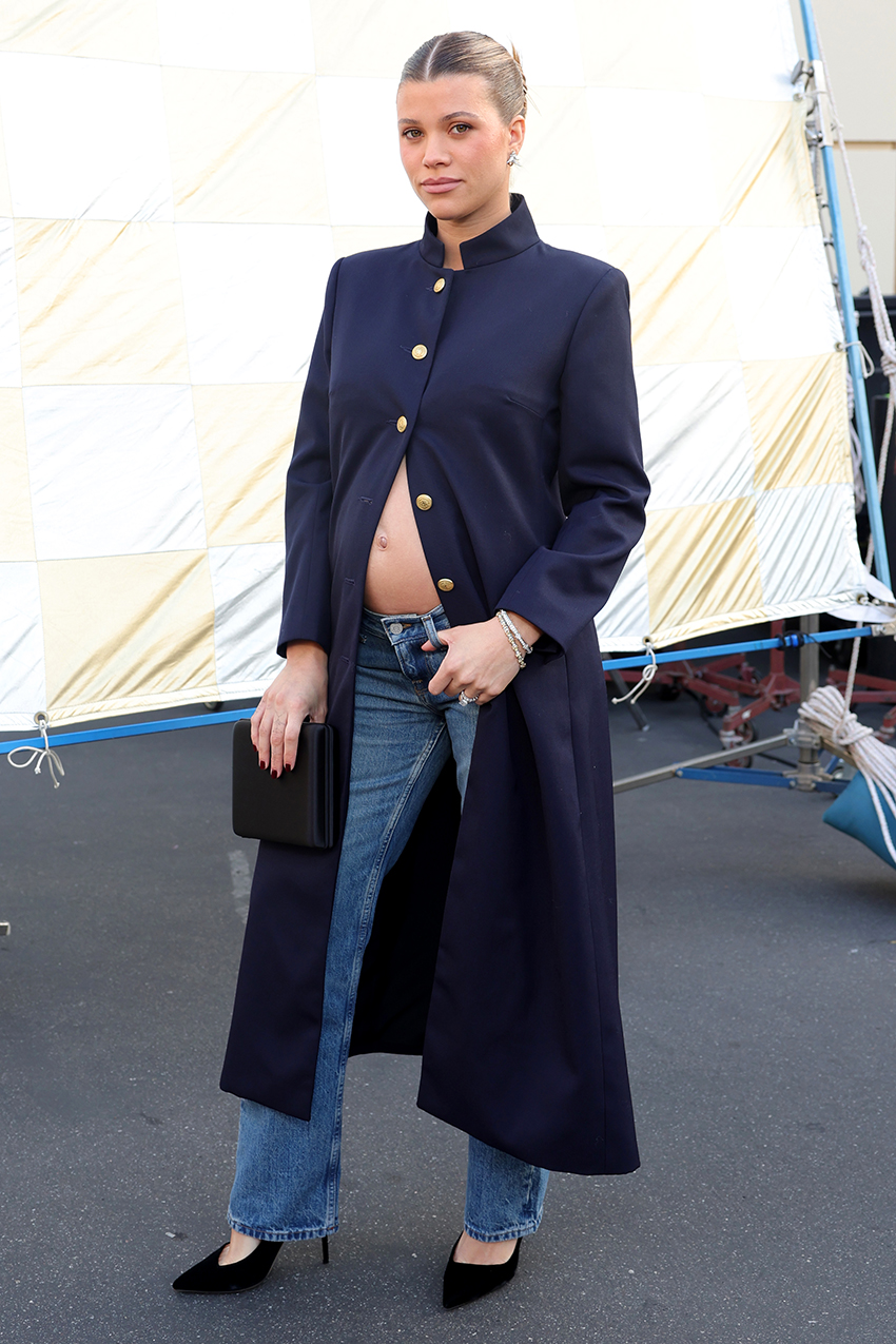 Sofia Richie wearing a navy coat, jeans, and black pumps at Vogue World 100 in Hollywood