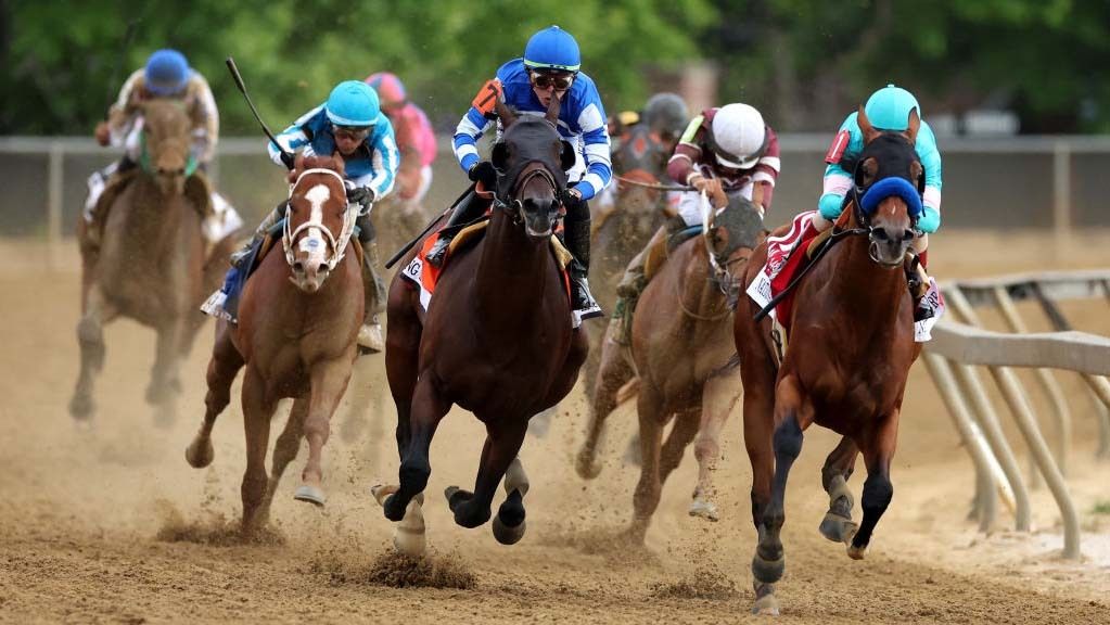 Jockey John Velazquez #1 on National Treasure (R) and jockey Irad Ortiz Jr. #7 aboard Blazing Sevens come out of the fourth turn during the 148th Running of the Preakness Stakes at Pimlico Race Course on May 20, 2023