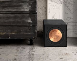 Klipsch Reference R-101SW subwoofer positioned on gray concrete floor