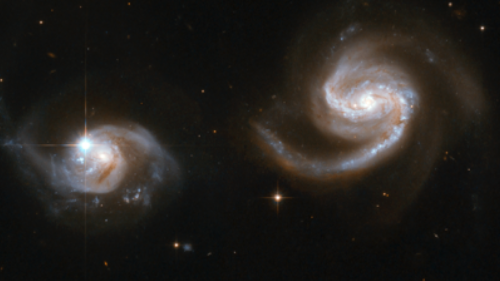 Two bright close white swirls against a black background