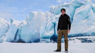 Brian Cox pictured standing on an ice flow in a still from his new science docuseries, "Solar System"