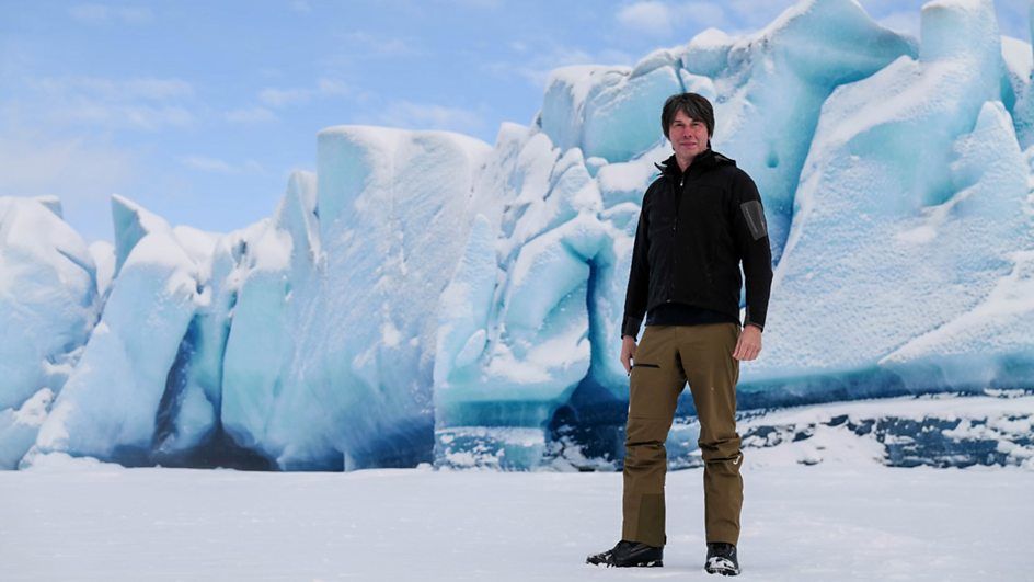 Brian Cox pictured standing on an ice flow in a still from his new science docuseries, &quot;Solar System&quot;