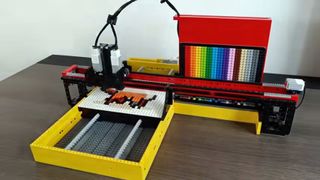 A '3D printer' of sorts that turns generative AI prompts into LEGO pictures, on a table, with lots of pretty coloured LEGO blocks