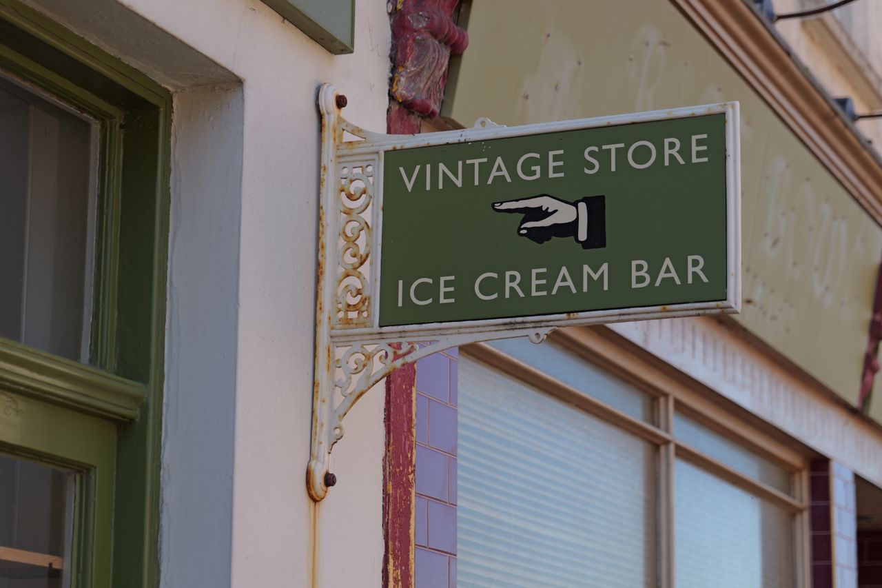 A sign for a vintage store and ice cream bar
