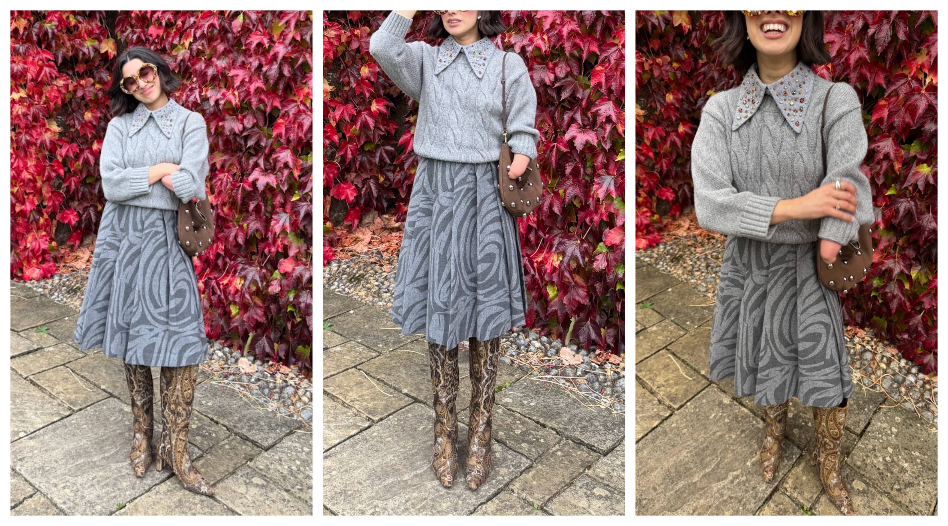 April Lockhart in front of fall leaves wearing a gray sweater and gray skirt