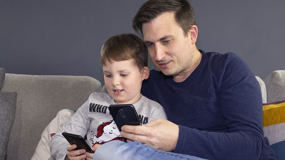 father and son with mobile phones