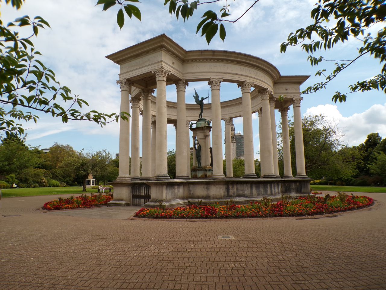 A statue of an angel surrounded by a stone monument