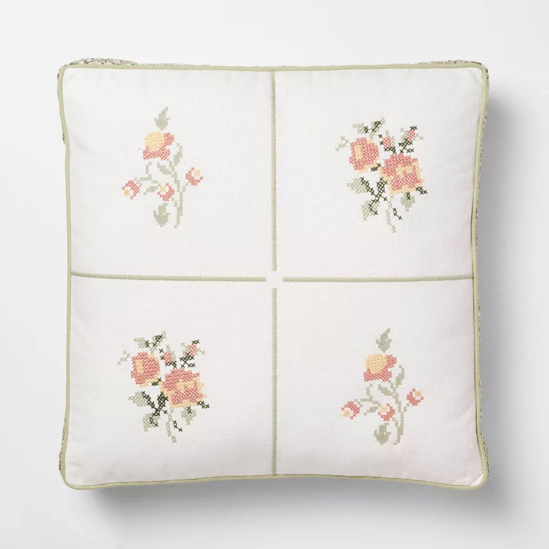 Pillow with floral cross stitch design
