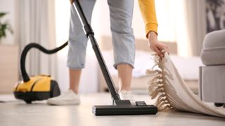 Woman vacuum cleaning floor