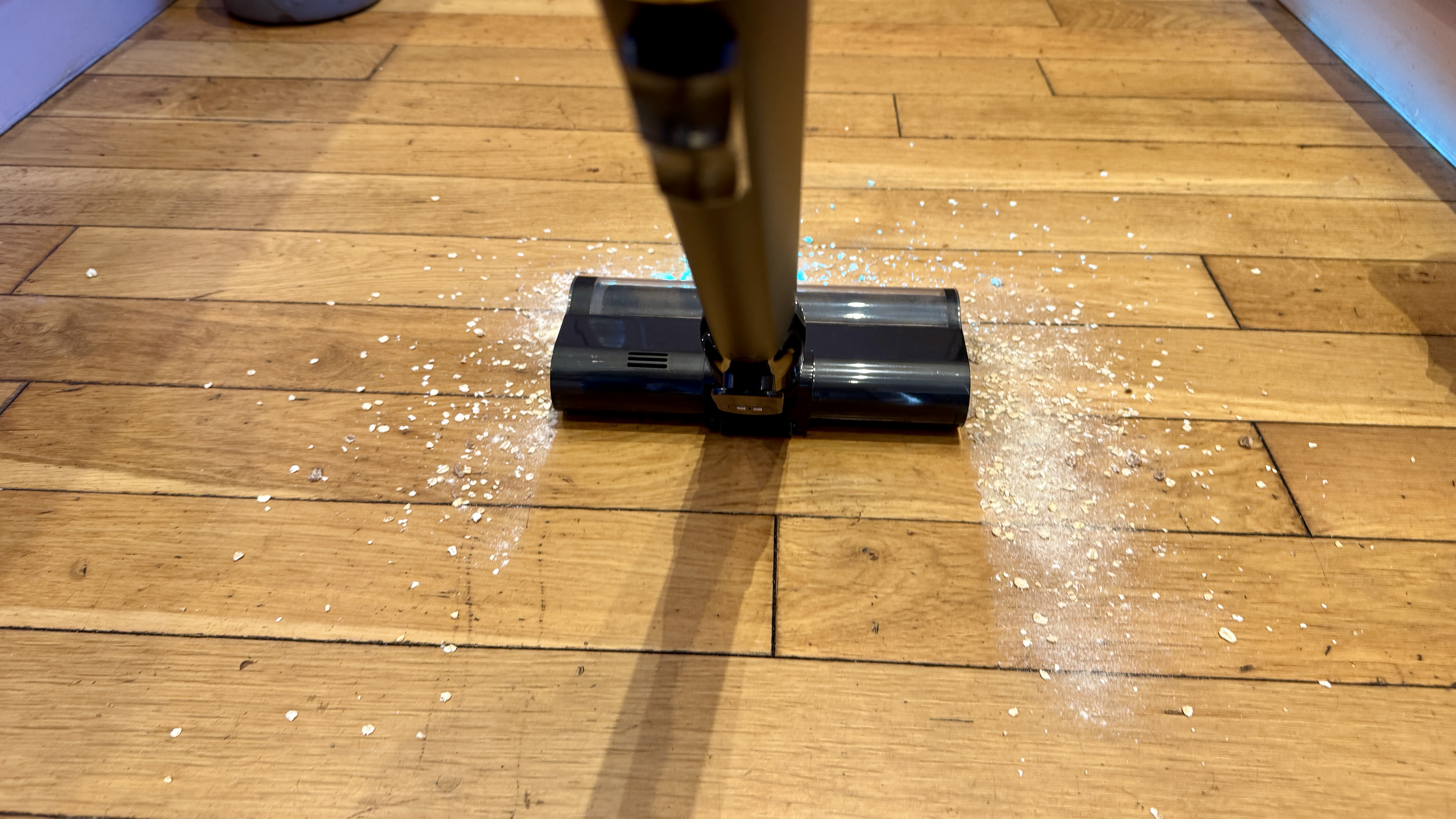 Dreame V20 Pro vacuum cleaning mess from a hard floor