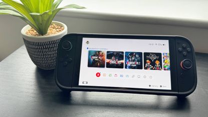 Nintendo Switch 2 console on a table displaying tiles for three Resident Evil games