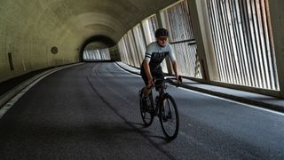 Man riding Cube Nuroad FE through a tunnel