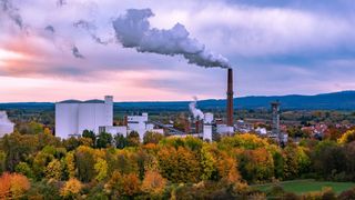 A factory with smoking chimneys.