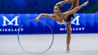 Sofia Raffaeli (ITA) performs a jumping splits in a blue sequinned leotard in the rhythmic gymnastics ahead of the 2024 Paris Olympic Games.