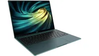 Huawei MateBook X Pro lightweight laptop shown on white background and in a dark silver colorway. The screen is open at an approximate orientation of 93 degrees and on the screen is a screensaver image showing swirling metal that is dark and cold at the periphery but glows yellow hot in the centre.