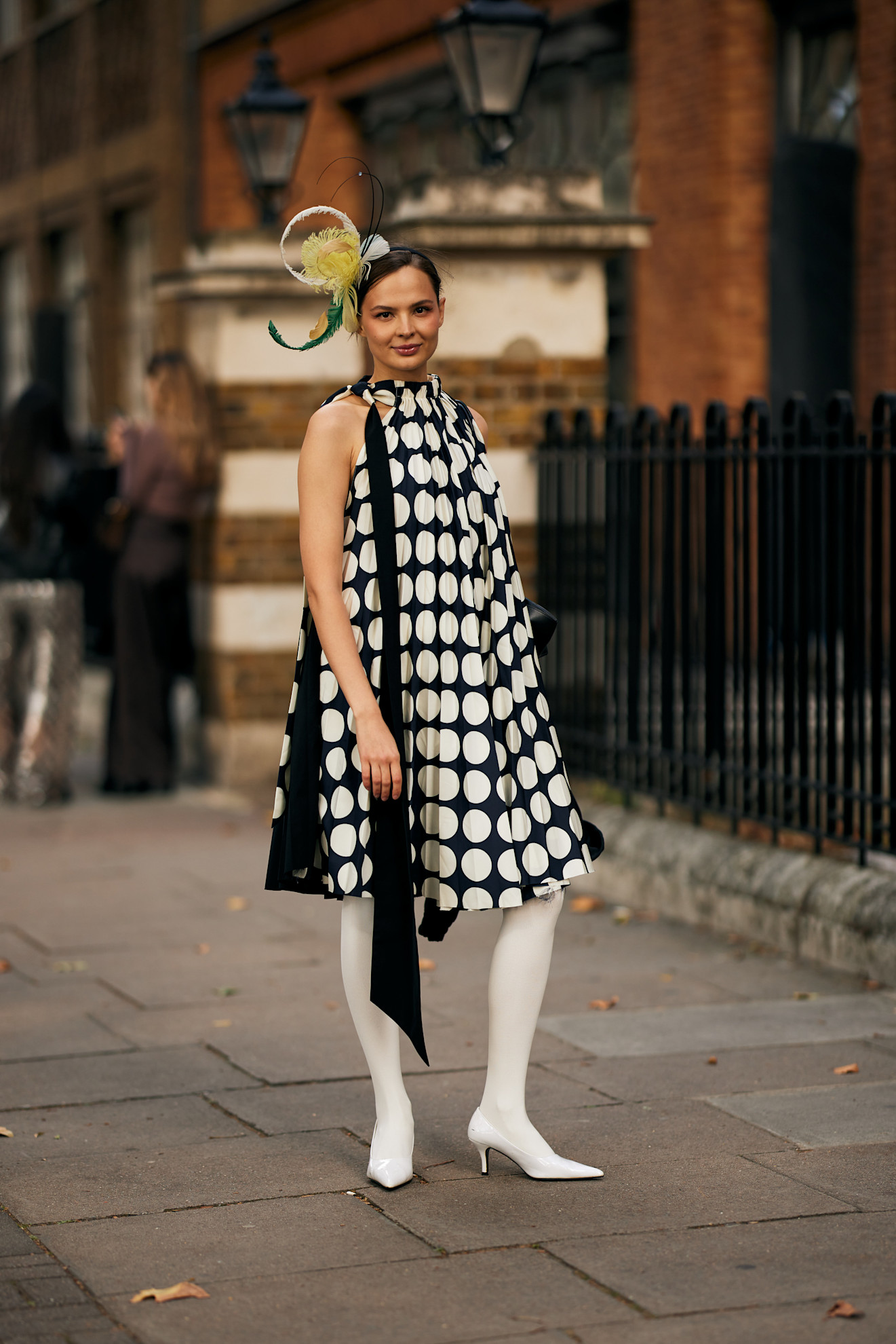woman in polka dot dress and white tights with fastener on her hair
