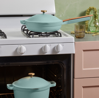 a blue pot and pan sitting on different shelves inside an oven
